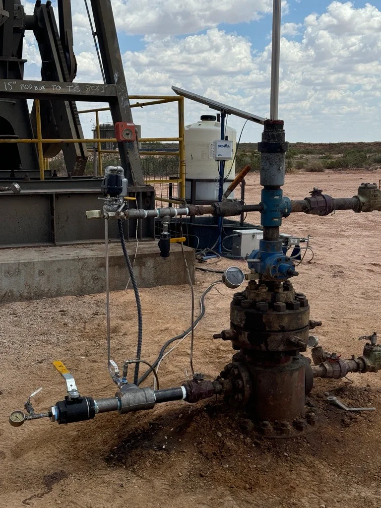 DCBatch system with solar panel beside a wellhead and pump jack