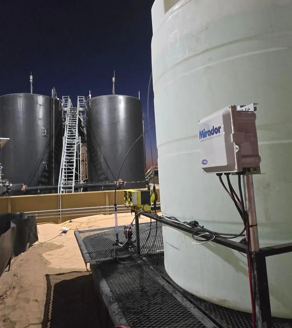 Mirador controller on a chemical tank at a tank battery at night