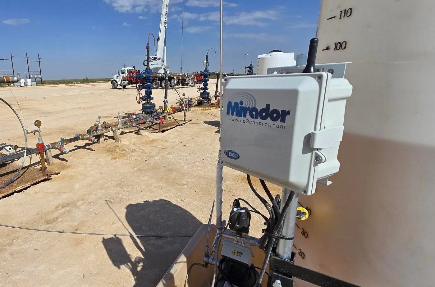 Mirador controller installed on a chemical tank with the wellhead behind it